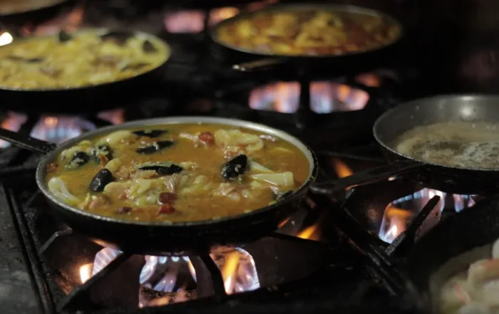 Random pans of food cooking on a stove