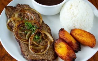 Grilled Steak and onions with Black Beans Whte Rice and fried Plantains
