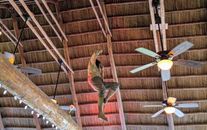 a mannequin simulating a pirate climbing down from the rafters