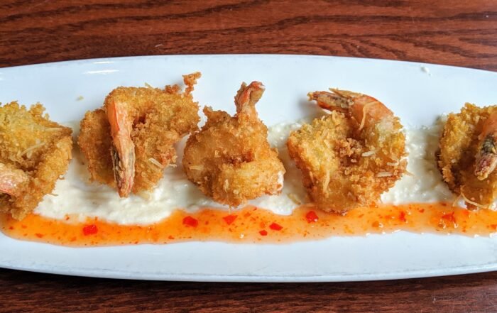 5 coconut batter fried shrimp ove a coconut and sweet chili sauce