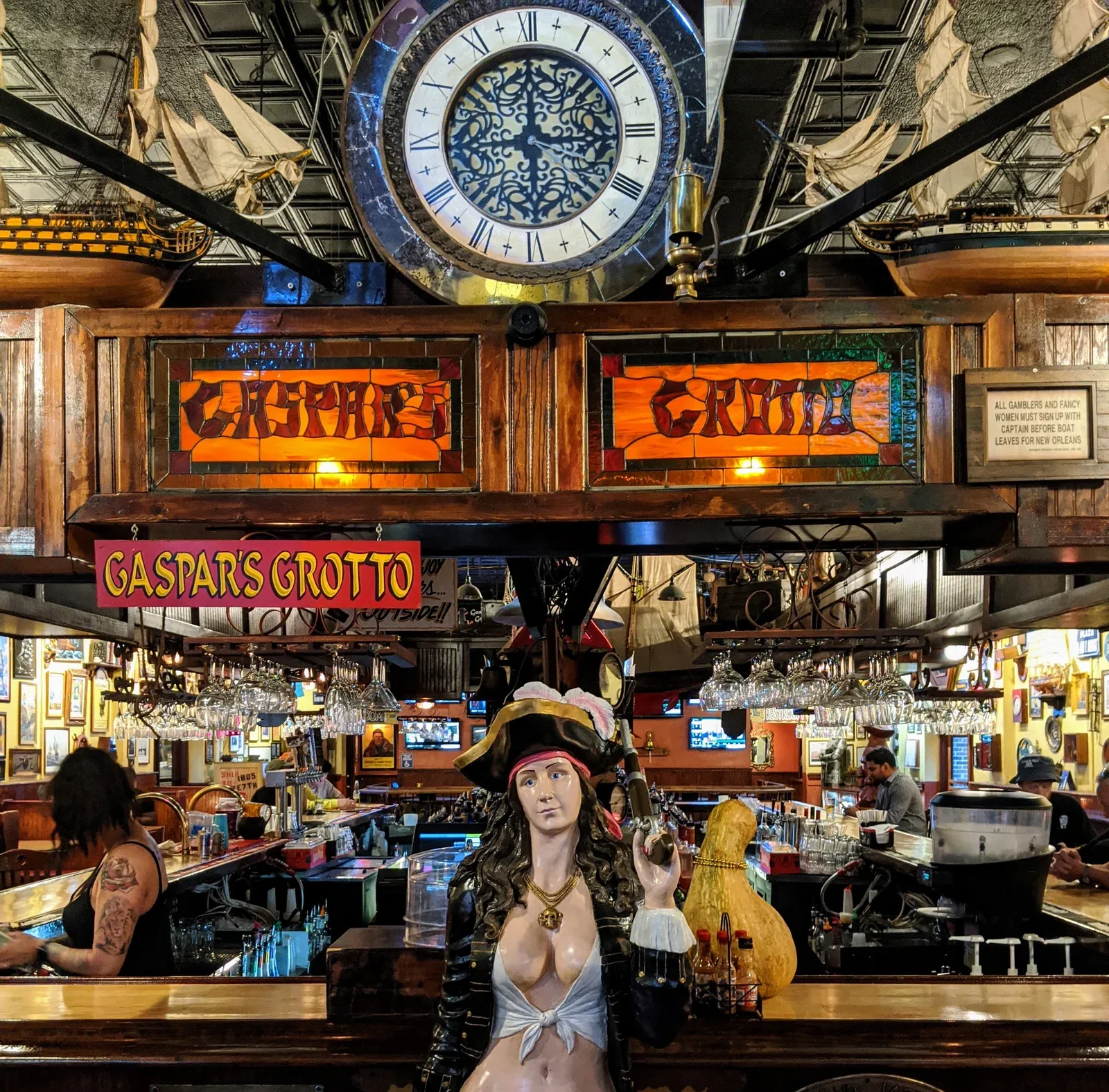 The entrance to Gaspars Grotto inlucing a clock, female statue of a pirate and the name Gaspars Grotto in stained glass