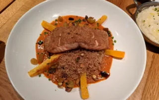 Grilled Salmon topped with Cous cous and steamed carot sticks
