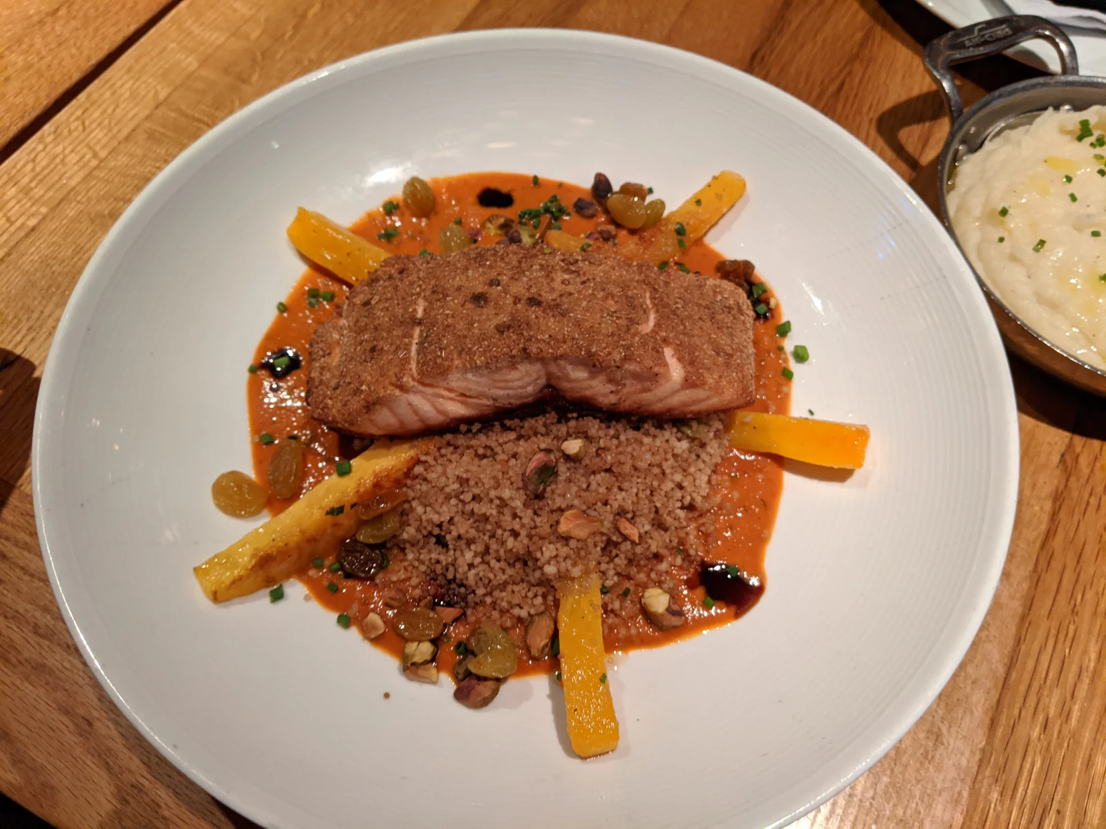 Grilled Salmon topped with Cous cous and steamed carot sticks