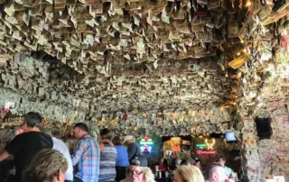 Dollar bills hanging from the ceiling of a bar