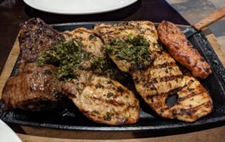 The Gaucho Platter, Grilled pork, chicken , beef and Chorizo on a sizzle plate