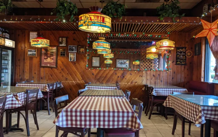 Wood Panel Dining Room with stained Glass Lights and Checkered Table Cloths