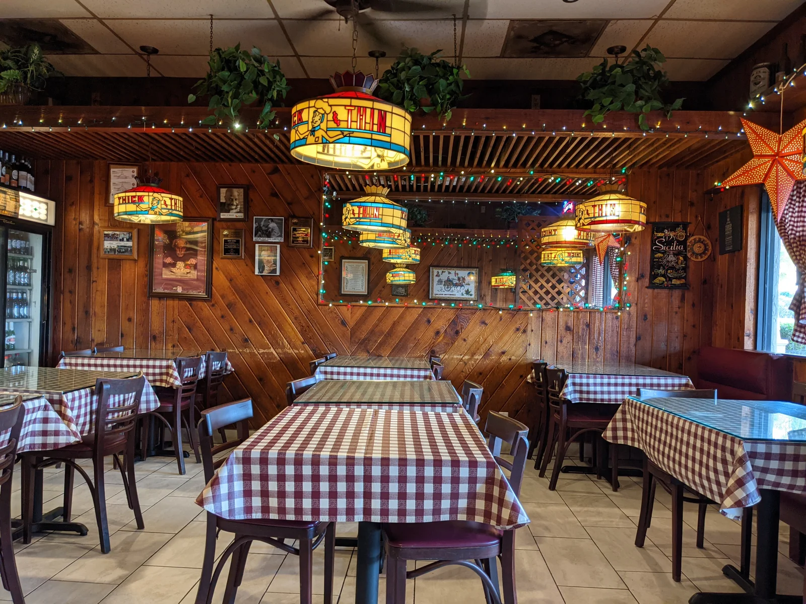 Wood Panel Dining Room with stained Glass Lights and Checkered Table Cloths