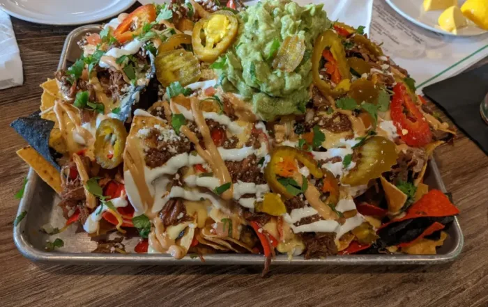 Nacho Chips topped with Meat, Cheese and Guacamole