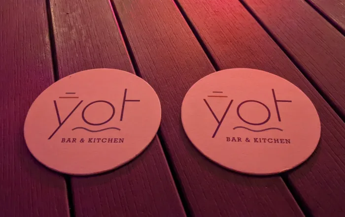 2 YOT coasters on a table