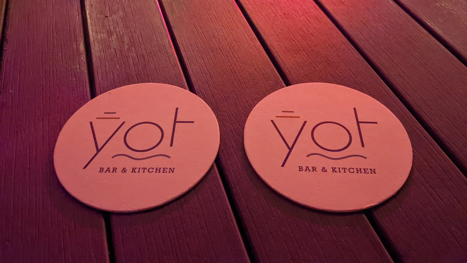 2 YOT coasters on a table