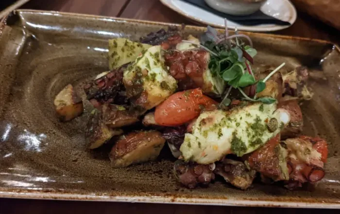 Grilled Octopus Salad topped with Greens