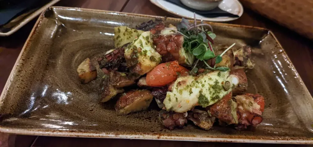 Grilled Octopus Salad topped with Greens