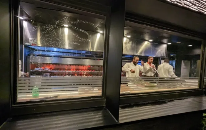 Chefs at Chima cooking meats in oven