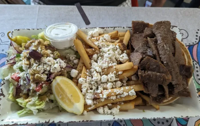 Gyro Platter with Tzatziki, Pita & Side Greek Salad with Dressing, and Greek Fries.