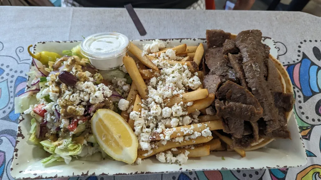 Gyro Platter with Tzatziki, Pita & Side Greek Salad with Dressing, and Greek Fries.
