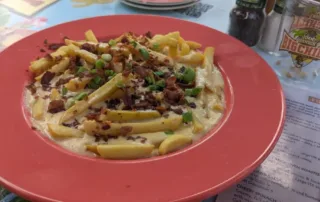 Fries in a shrimp Bisque topped with Bacon