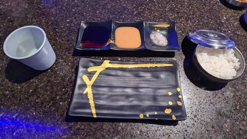 Proper Korean BBQ Setup - water Sauces, Salt and Pepper and an empty plate