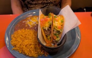 2 Pork tacos, yellow rice and refried beans