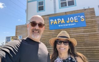 2 people in front of sign