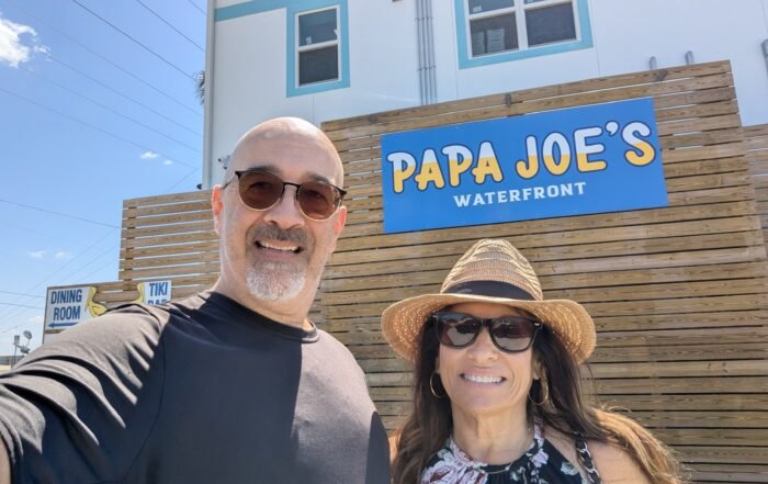 2 people in front of sign