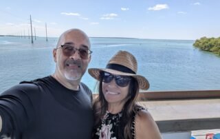 2 people on deck overlooking bay