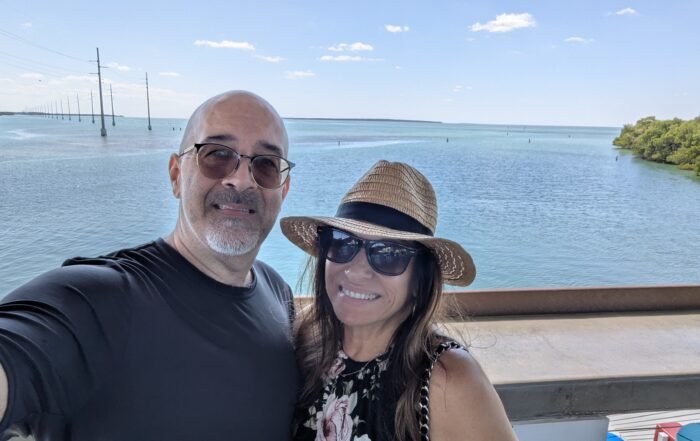 2 people on deck overlooking bay