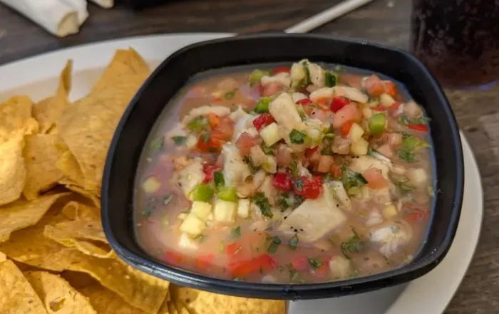A bowl oc Cervichi (mixed seafood in an citic brine) and plantain chips