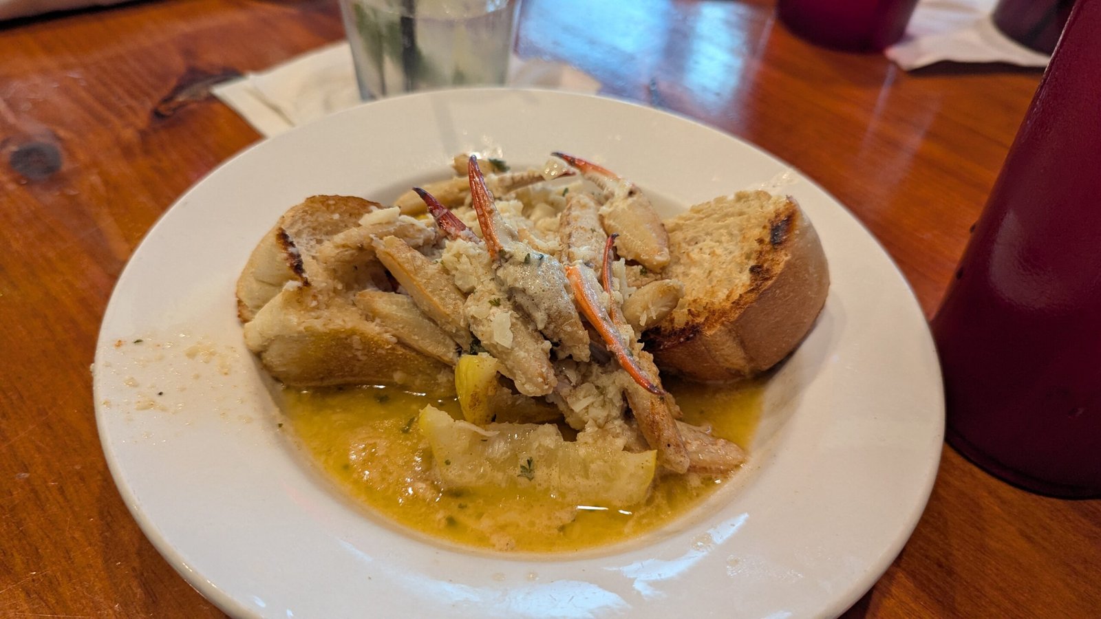 Shelled Crab Claws in a garlic sauce over bread