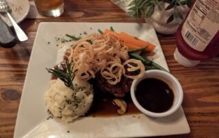 Meatload Special with Mashed Potatoes topped with fries onion curls.