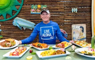 Owner of Kay with mutiple dishes on a table