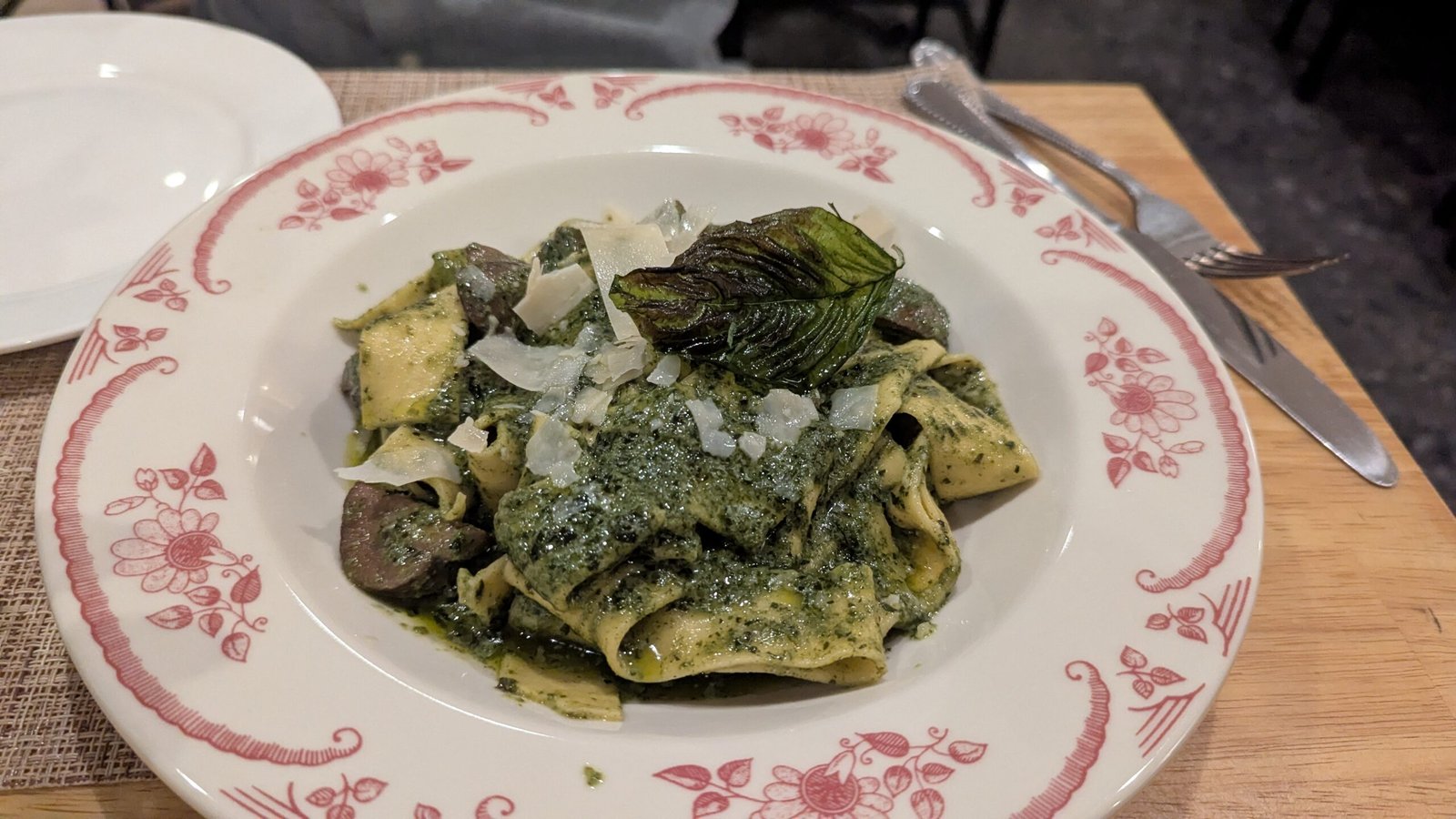 Pasta topped with a pesto sauce and Mushrooms