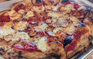 Sardegna: Pizza topped with thinly sliced, perfectly grilled octopus, fresh mozzarella, garlic, and parsley. Finished with Pecorino Romano and a drizzle of EVOO