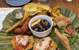 Mariquitas, Croquetas de Jamon, Picadillo Empanadas, Fiesta Tostones, and that signature Black Bean Salsa
